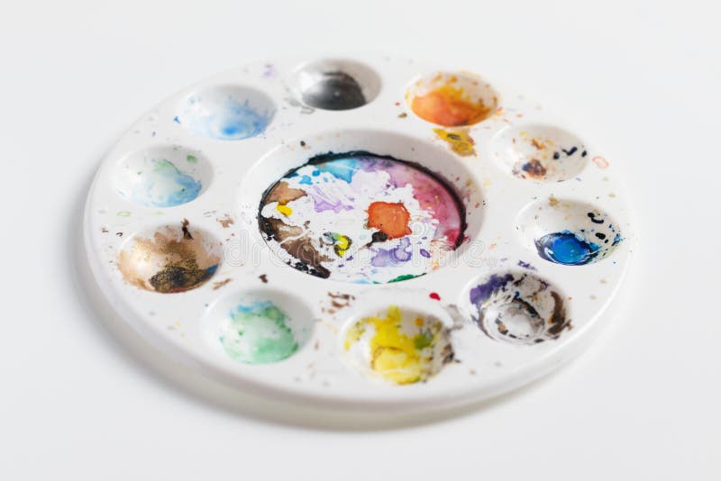 Artist palette full of dried coloured paint royalty free stock photo
